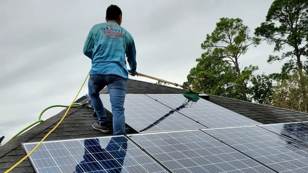 Gravity Wave technician cleaning solar panels with a professional brush